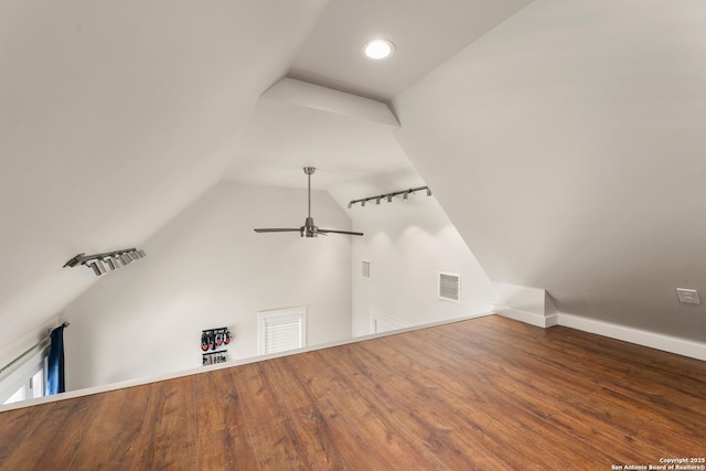 bonus room featuring ceiling fan, visible vents, wood finished floors, and vaulted ceiling