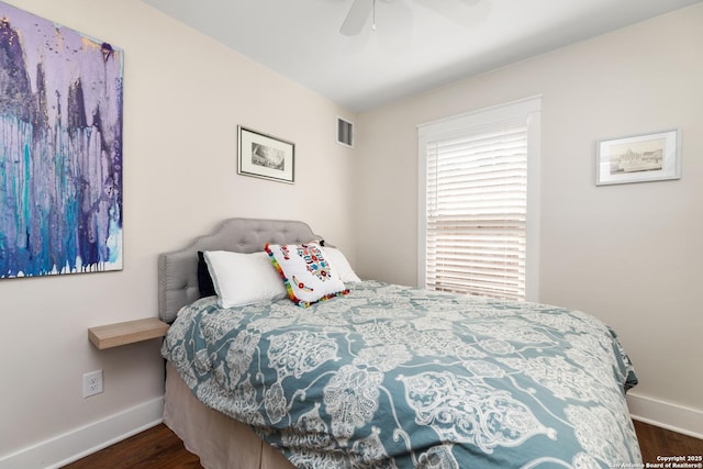 bedroom featuring wood finished floors, baseboards, visible vents, and ceiling fan