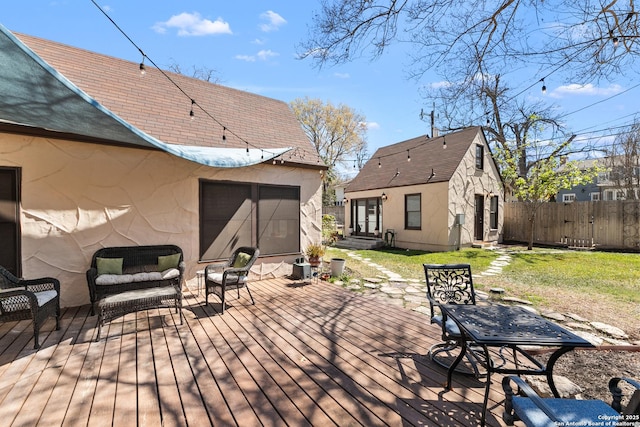 wooden terrace with a lawn, entry steps, outdoor lounge area, and fence