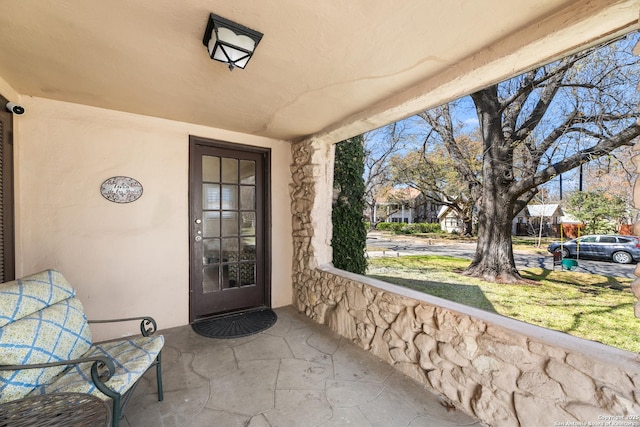 entrance to property with stucco siding