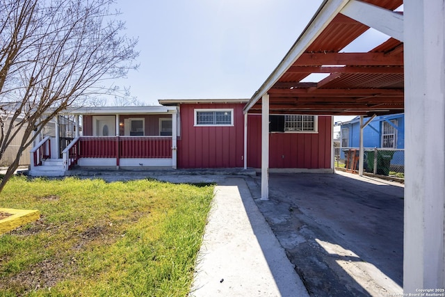 single story home with a carport and board and batten siding