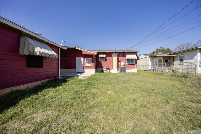 view of yard featuring cooling unit and fence