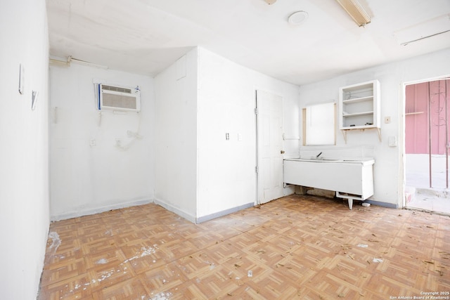 spare room with a wall mounted air conditioner and baseboards