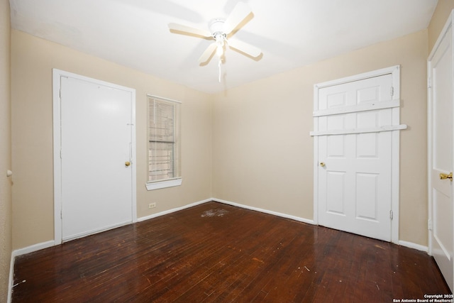 spare room featuring baseboards, wood-type flooring, and ceiling fan