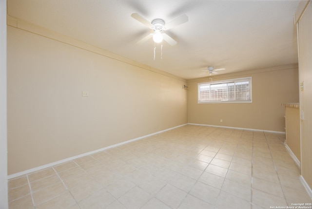 spare room featuring light tile patterned floors, baseboards, a ceiling fan, and ornamental molding