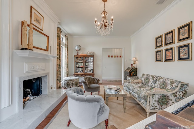 living area featuring wood finished floors, a notable chandelier, a fireplace, and ornamental molding