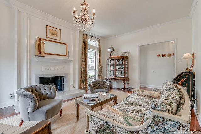 interior space with a tiled fireplace, wood finished floors, baseboards, and ornamental molding