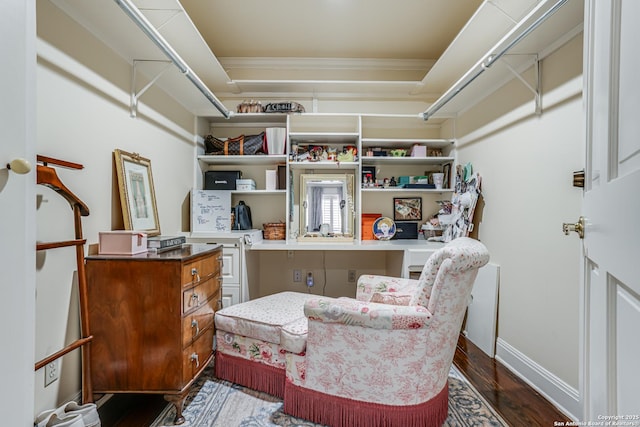 interior space with crown molding, baseboards, dark wood-style flooring, and built in study area