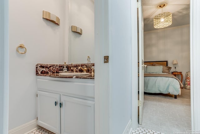 bathroom with tile patterned floors, baseboards, and vanity