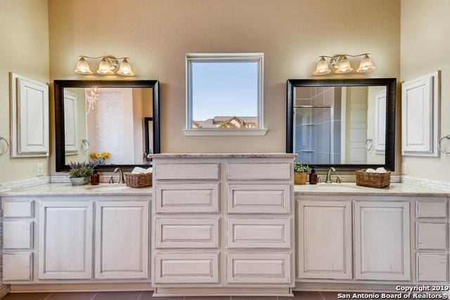 bathroom featuring vanity and a shower