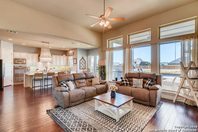 living room featuring visible vents, a healthy amount of sunlight, and dark wood-style floors