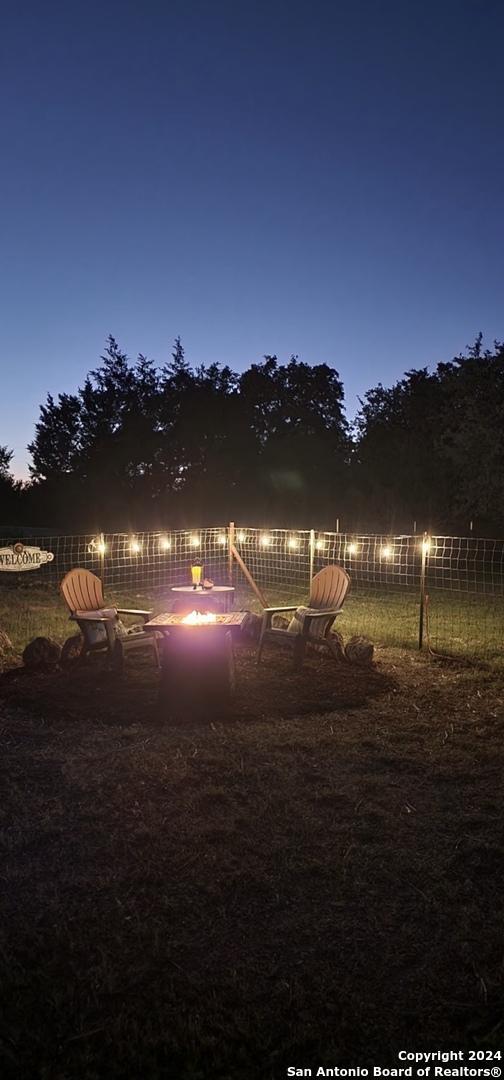 view of water feature with a fire pit and fence