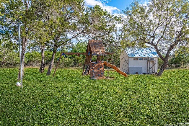 view of yard with a storage unit, an outbuilding, and a playground