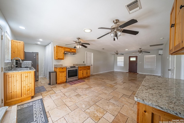 kitchen with visible vents, under cabinet range hood, recessed lighting, appliances with stainless steel finishes, and stone tile flooring