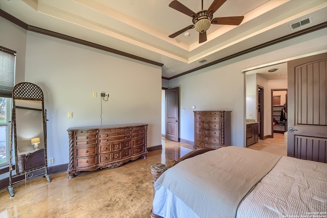 bedroom with a tray ceiling, baseboards, visible vents, and crown molding