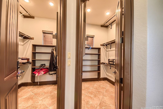 spacious closet with light tile patterned floors