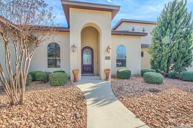 entrance to property featuring stucco siding