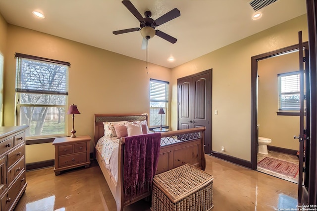 bedroom with visible vents, multiple windows, and baseboards