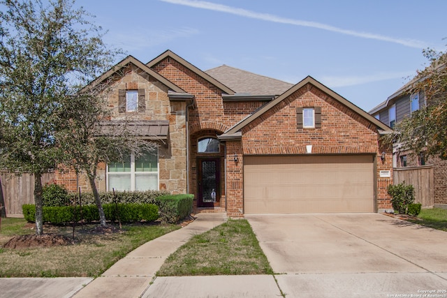 view of front of property featuring a garage, fence, brick siding, and stone siding