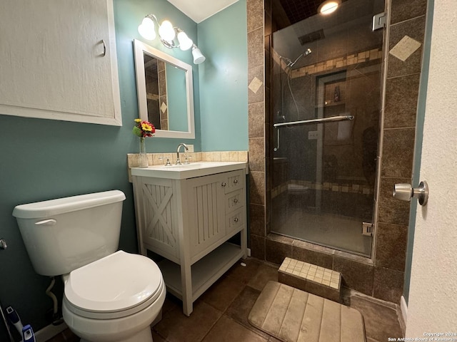 full bathroom featuring vanity, toilet, and a shower stall