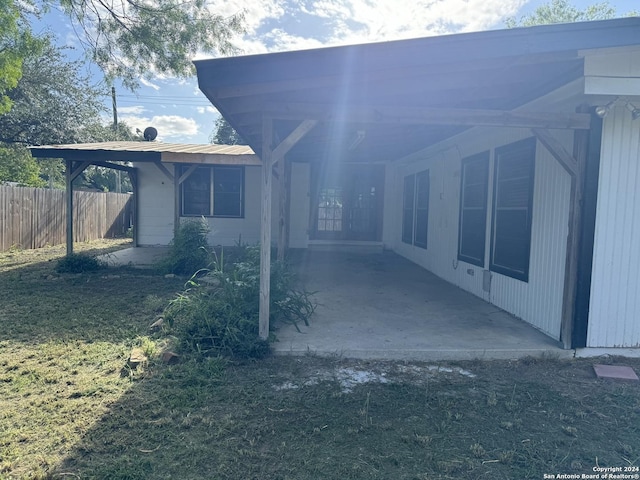 back of property with a patio area and fence