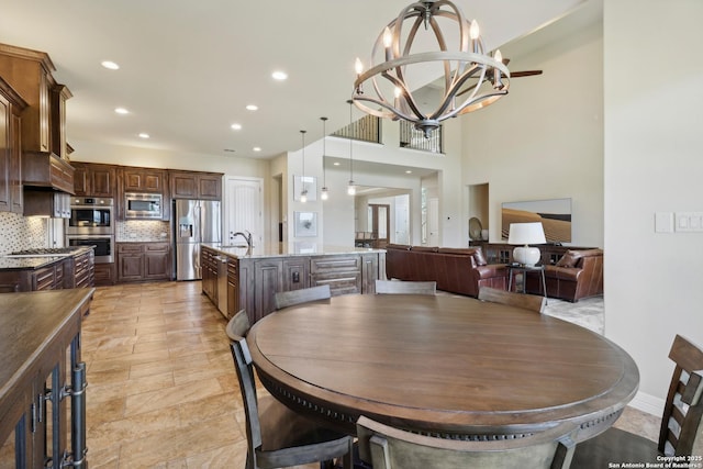 dining room with recessed lighting and an inviting chandelier