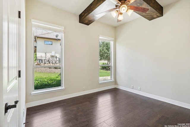 spare room with beam ceiling, baseboards, dark wood-type flooring, and a ceiling fan