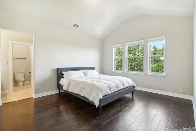 bedroom featuring vaulted ceiling, visible vents, baseboards, and wood finished floors