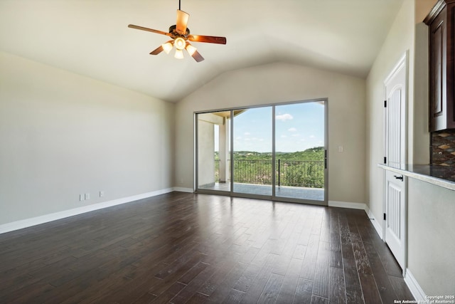 unfurnished room featuring dark wood-style floors, baseboards, lofted ceiling, and ceiling fan