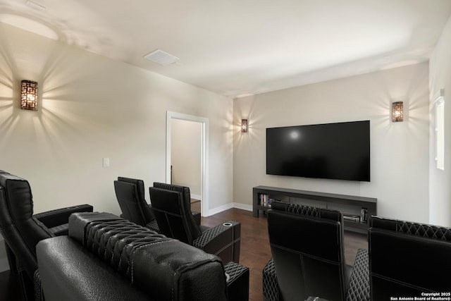 cinema featuring visible vents, dark wood-style floors, and baseboards