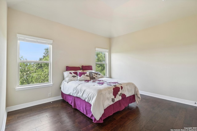 bedroom featuring baseboards and dark wood-style floors