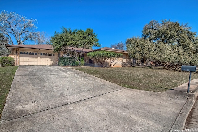 ranch-style home featuring concrete driveway, a garage, brick siding, and a front lawn