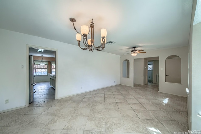 unfurnished room featuring light tile patterned floors, visible vents, baseboards, arched walkways, and ceiling fan with notable chandelier