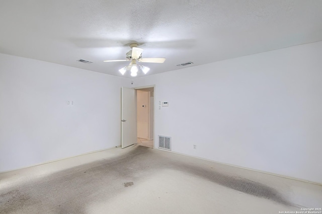 spare room with visible vents, a textured ceiling, and ceiling fan