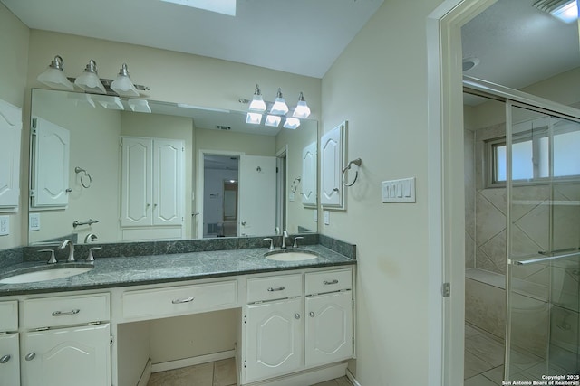 full bathroom with a shower stall, double vanity, and a sink