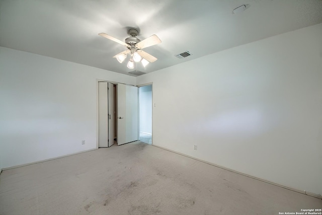 spare room featuring visible vents and ceiling fan