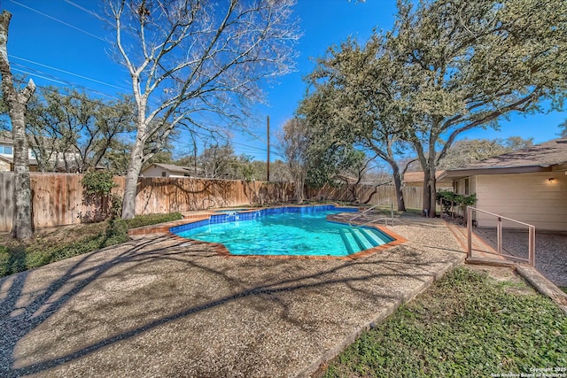 view of swimming pool featuring a patio, a fenced backyard, and a fenced in pool