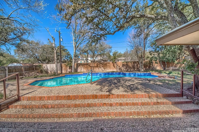 view of swimming pool with a fenced backyard and a fenced in pool