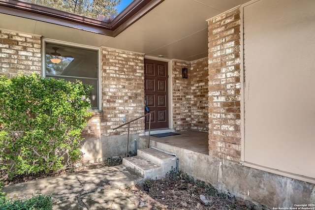 entrance to property featuring brick siding