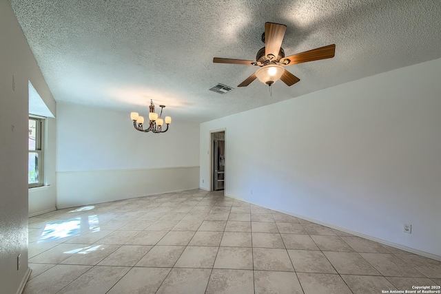 empty room with light tile patterned floors, visible vents, and a textured ceiling