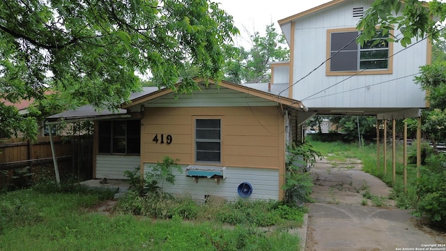 back of house featuring fence