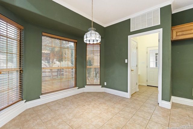 unfurnished dining area featuring light tile patterned floors, baseboards, visible vents, and ornamental molding