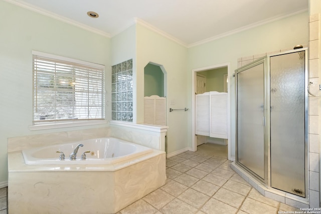 bathroom with baseboards, a garden tub, a shower stall, and crown molding