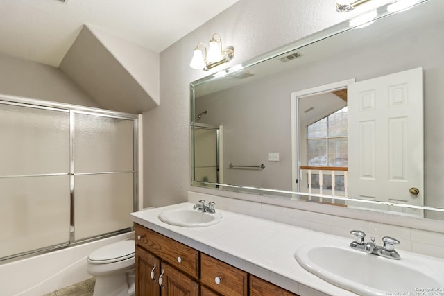 full bathroom with a sink, visible vents, toilet, and double vanity