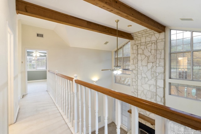 hallway with beam ceiling, visible vents, an upstairs landing, and high vaulted ceiling