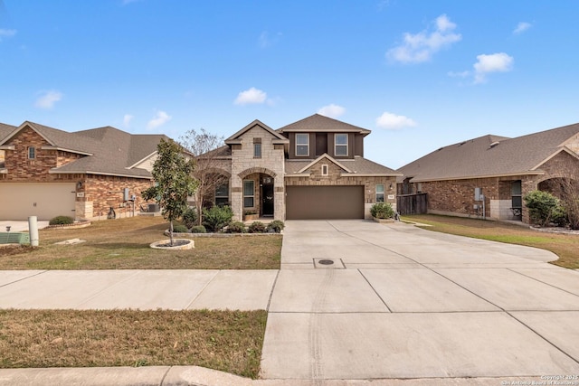 view of front of home with stone siding, a garage, concrete driveway, and a front yard