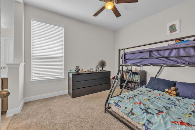 carpeted bedroom featuring a ceiling fan and baseboards