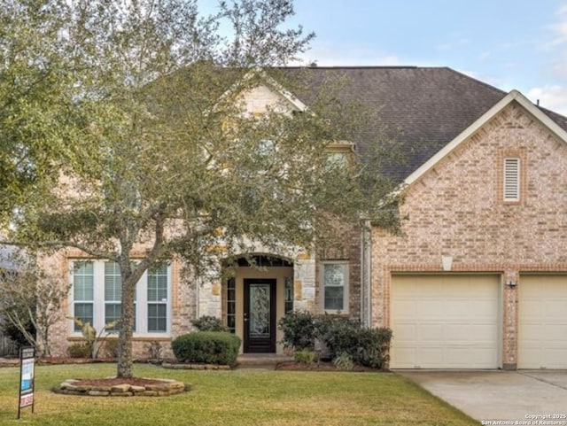 view of front of home with a front yard, a shingled roof, concrete driveway, a garage, and brick siding