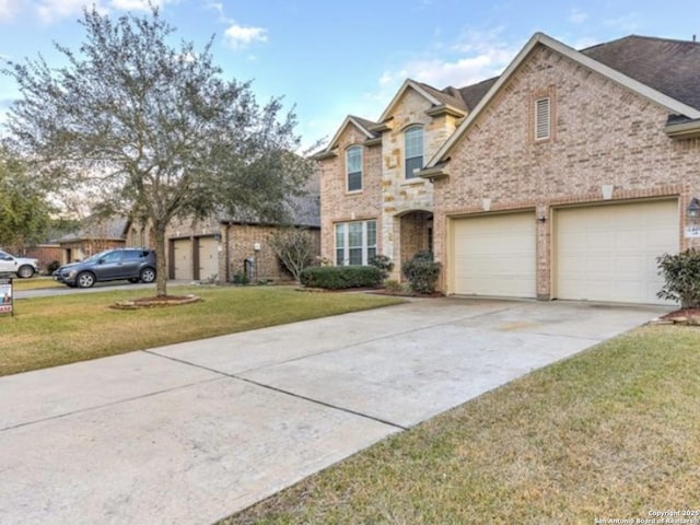 traditional home with brick siding, an attached garage, concrete driveway, and a front yard