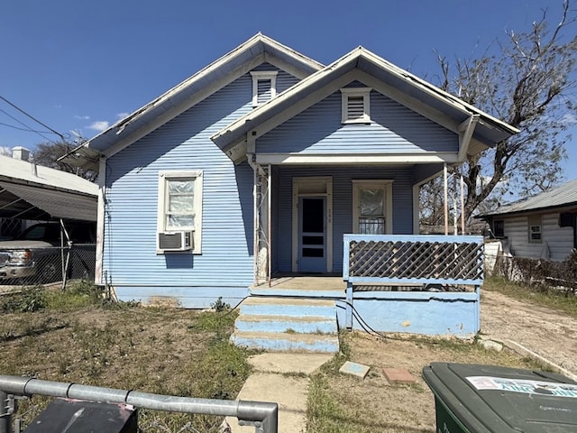 view of front of home with cooling unit, a porch, and fence